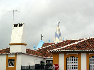 Schornsteine wie »betende Hände« und Kirchturm im blau-weißen Fliesenlook: Über den Dächern von Angra do Heroísmo (Foto: Eichner-Ramm)